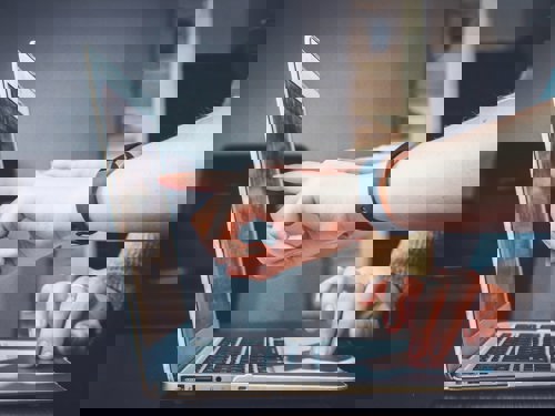 person pointing at laptop screen