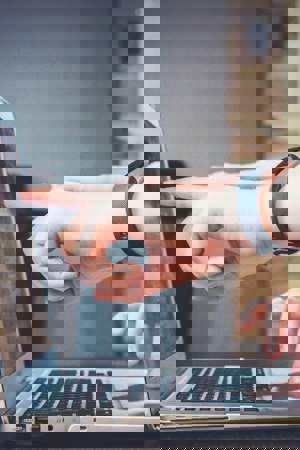 person pointing at laptop screen