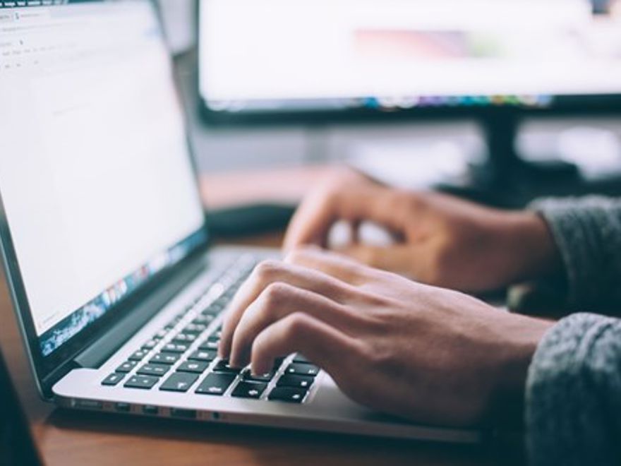 person typing on latop